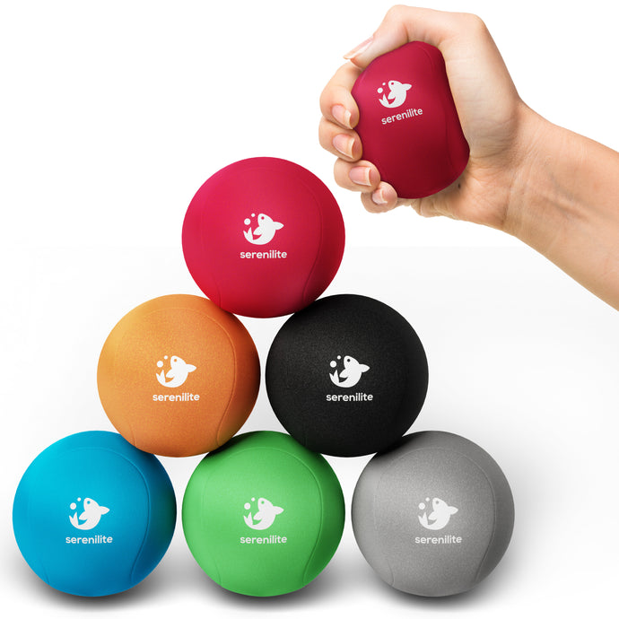 Serenilite Hand Therapy Stress Balls 6 pack in red, orange, black, blue, green and grey, one squeezed in hand
