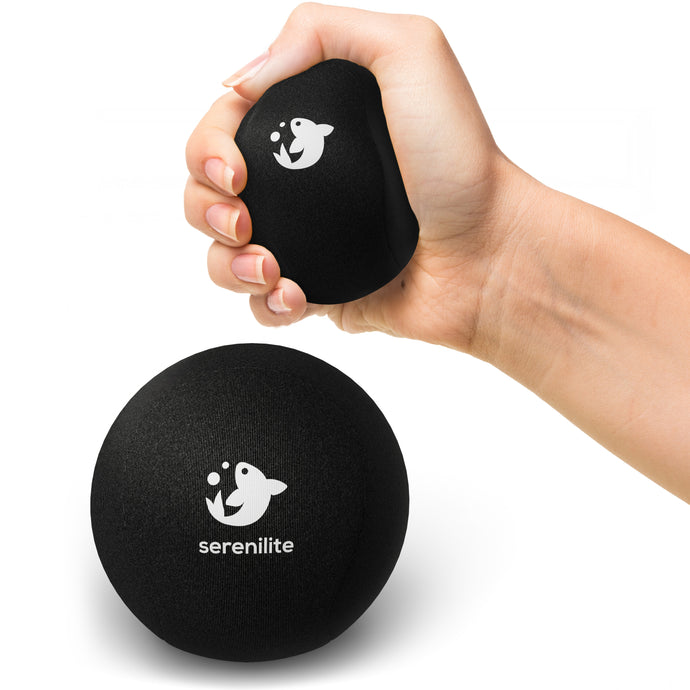 Serenilite Hand Therapy Stress Ball in Jet Black, squeezed in hand to show size and soft gel give