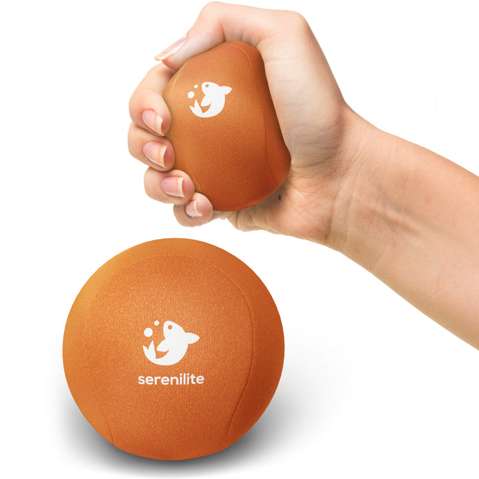 Serenilite Hand Therapy Stress Ball in Morning Sun orange, squeezed in hand to show size and soft gel give