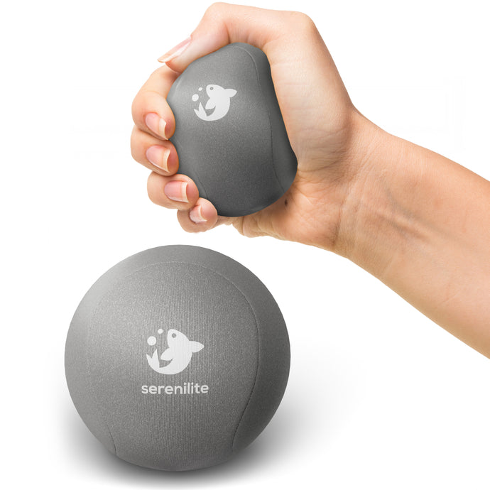 Serenilite Hand Therapy Stress Ball in Titanium grey, squeezed in hand to show size and soft gel give